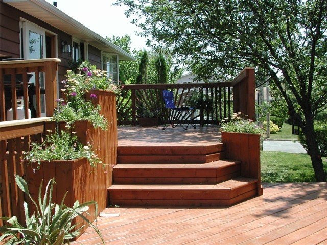 Multi-level wood deck with steps and built-in planter boxes