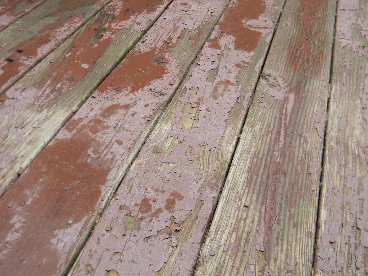 Peeling finish and weathered deck boards