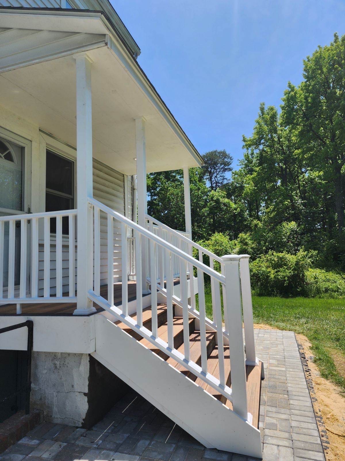 White porch stairs paver walkway