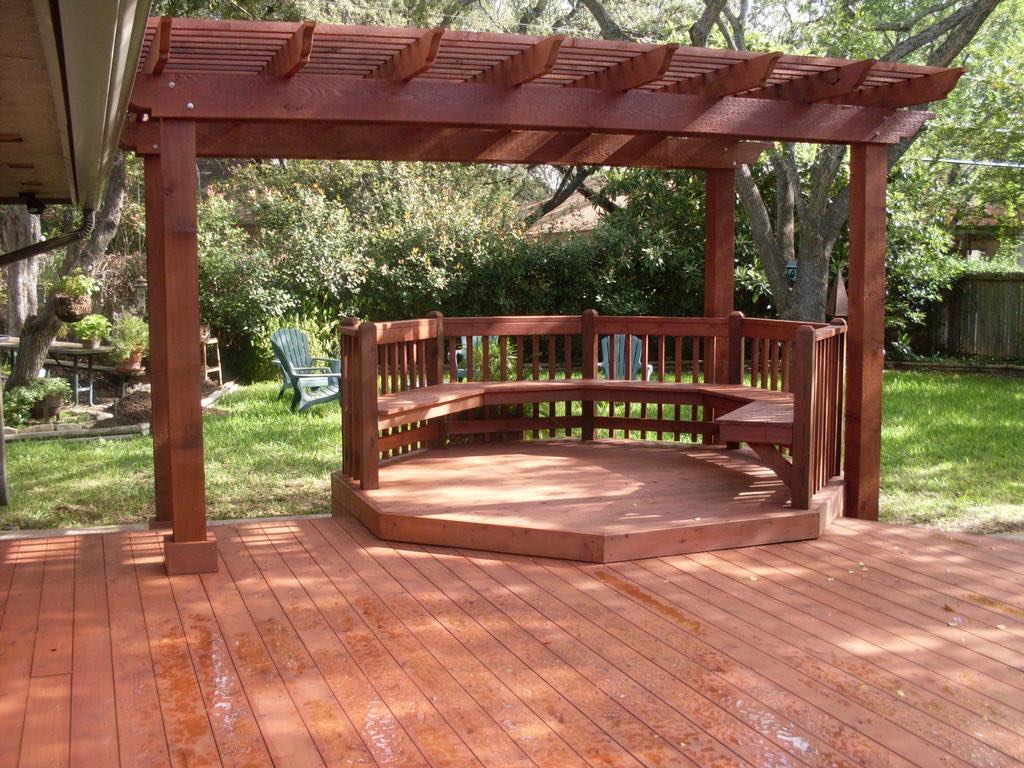 Wood deck arbor with curved built-in bench seating