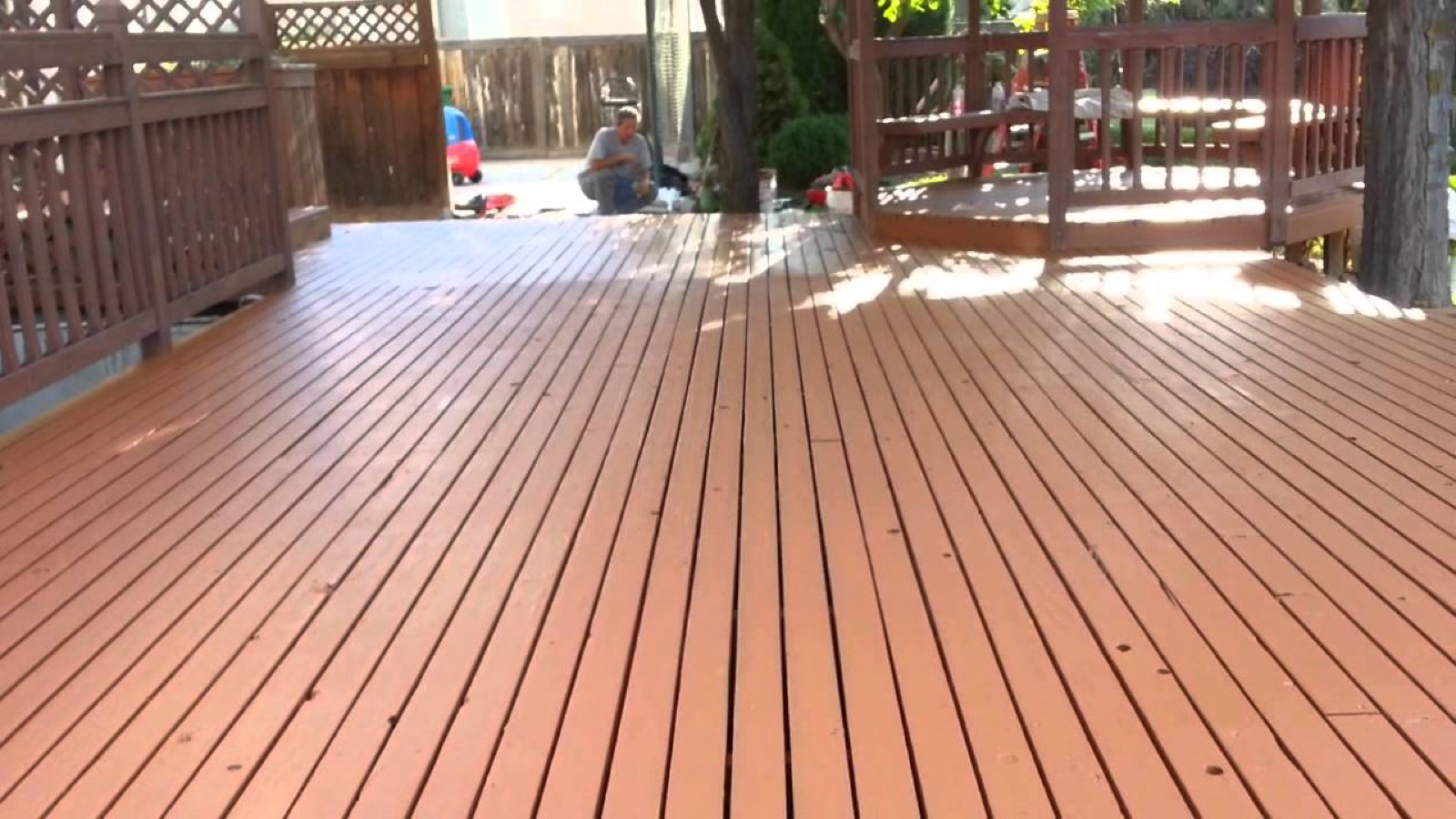 Large wood deck with a consistent renewed surface and surrounding wood railings